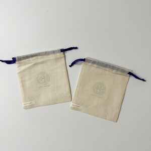Two Tory Burch Cream Canvas Drawstring Pouches with Purple Trim